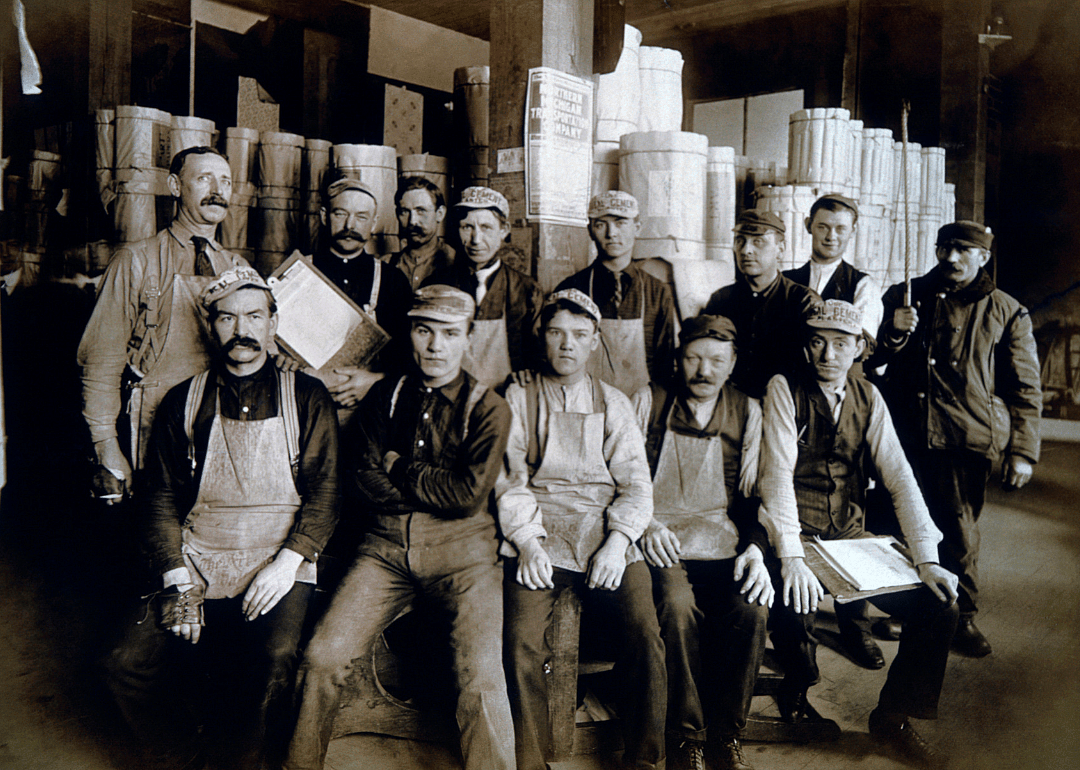 Group of men seated in warehouse