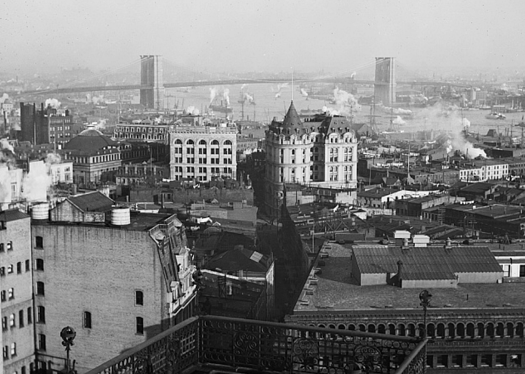 Elevated view of buildings with Brooklyn Bridge in the distance