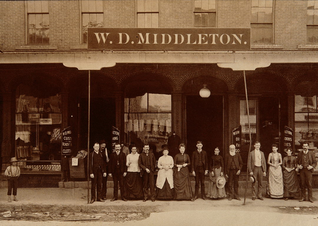 Employees and boy in front of clothing store